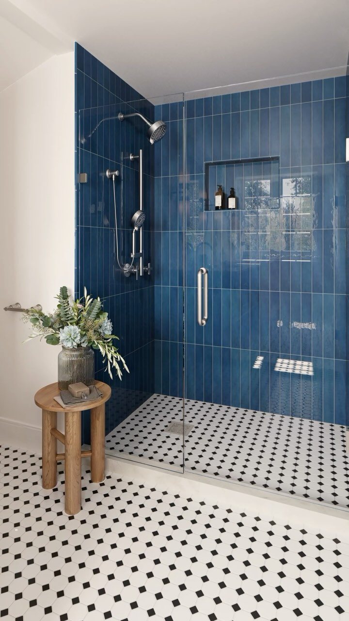 Blue tiled shower walls and black and white patterned tile flooring in a modern bathroom.