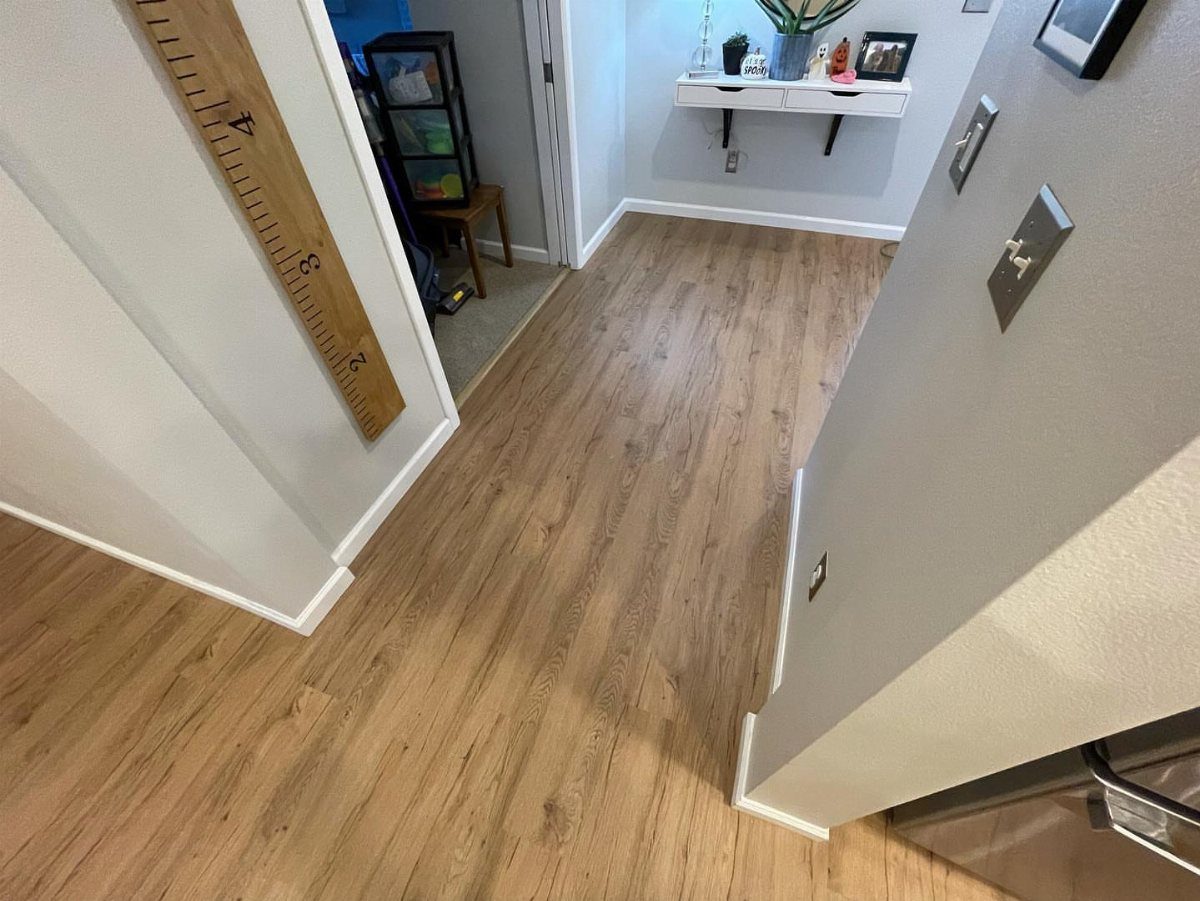 Lifeproof Easy Oak: 8 Installations That Show the Plank's Real Range 4 Light oak wood grain luxury vinyl plank flooring installed in a bright hallway.