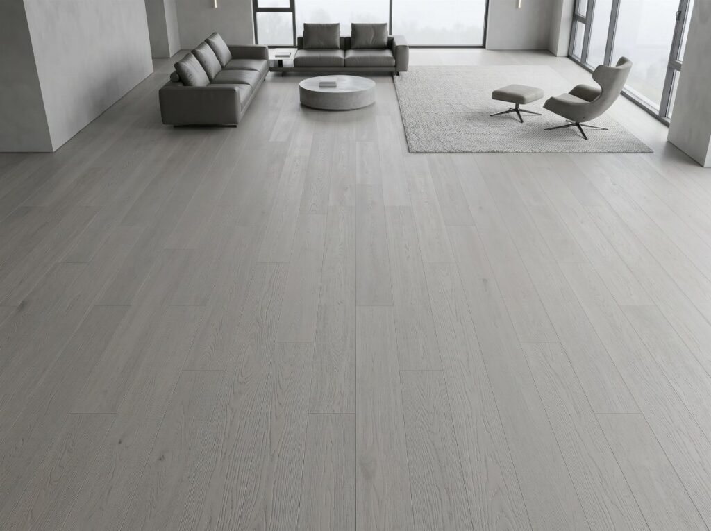 Light gray wood flooring in a modern, minimalist living room with gray furniture.
