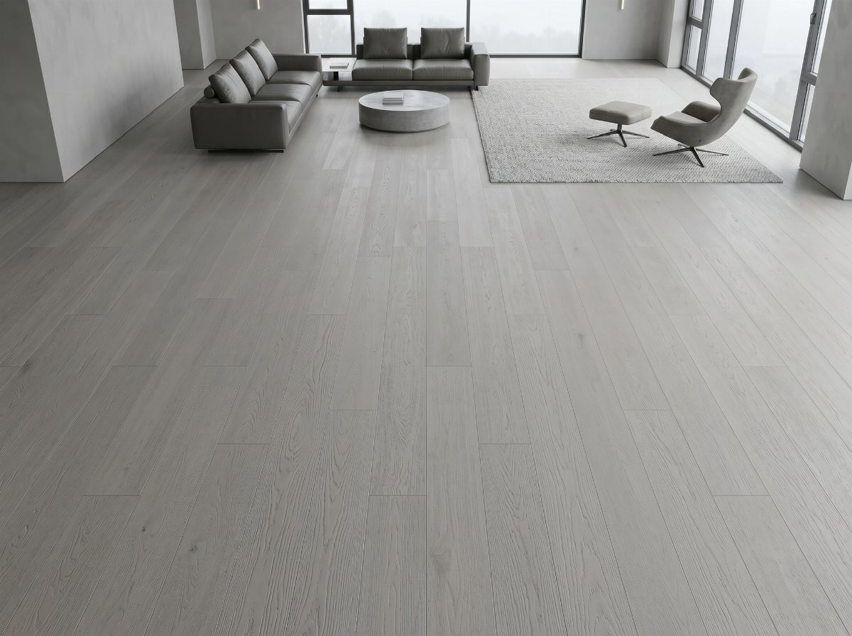 Light gray wood flooring in a modern, minimalist living room with gray furniture.