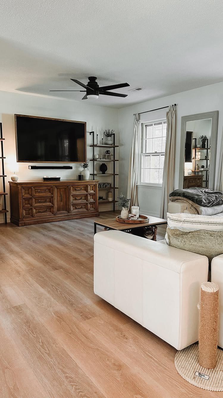 Lifeproof Easy Oak: 8 Installations That Show the Plank's Real Range 2 Light oak wood plank flooring in a bright, modern living room with white furniture.